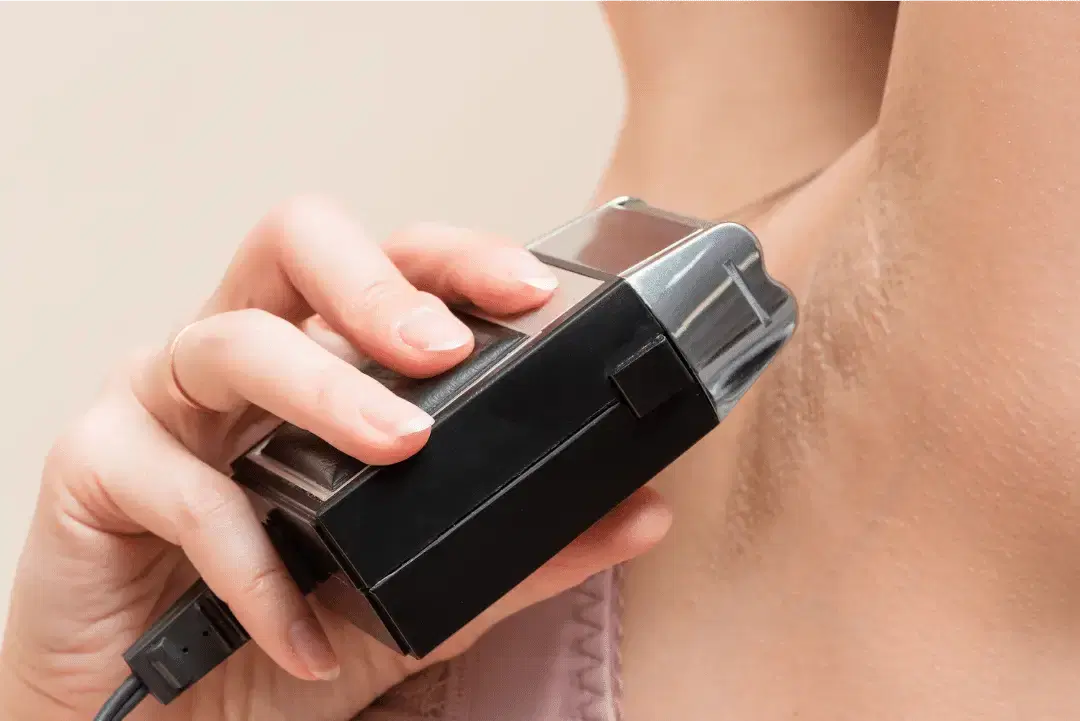 Using an electric body trimmer to pre-shave butt hair before finishing with a razor