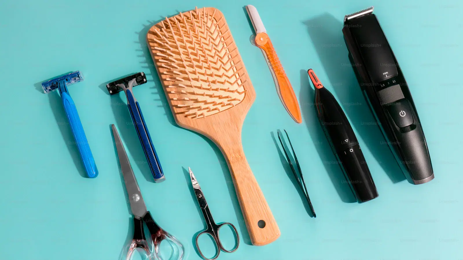 Five body trimmers for men laid out on a bathroom counter — Manscaped Lawn Mower, Philips OneBlade, Braun, Panasonic, Remington tested 2026