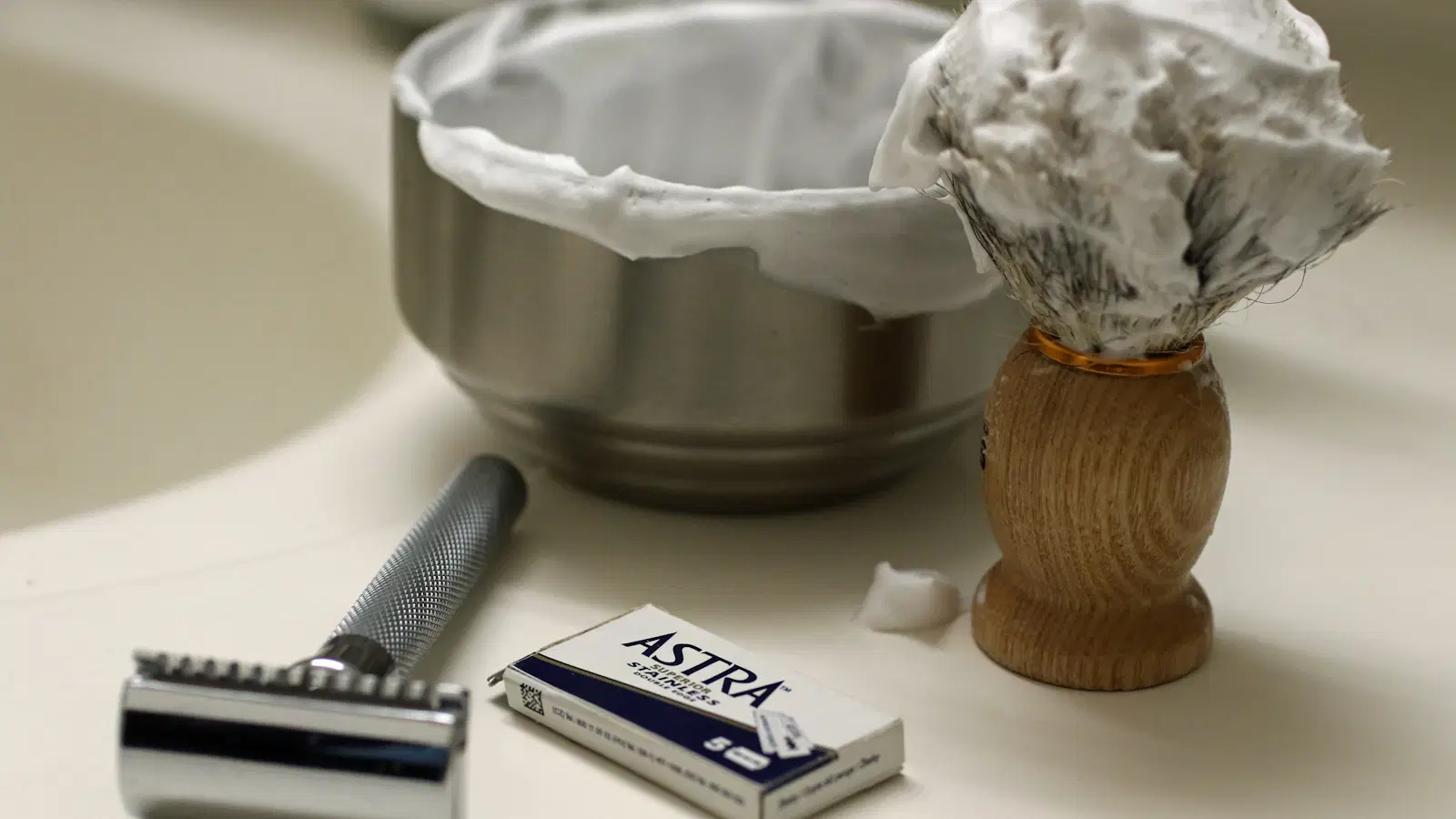 Five electric trimmers built for pubic hair laid out on a bathroom counter — the best pubic trimmer picks for men in 2026