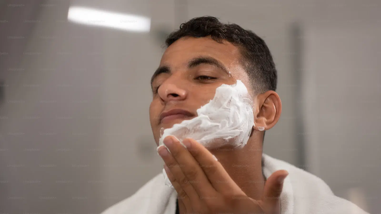 Bevel Priming Cream being applied thickly to pubic area — extra soak time for coarse and curly hair, prevents ingrowns at the follicle
