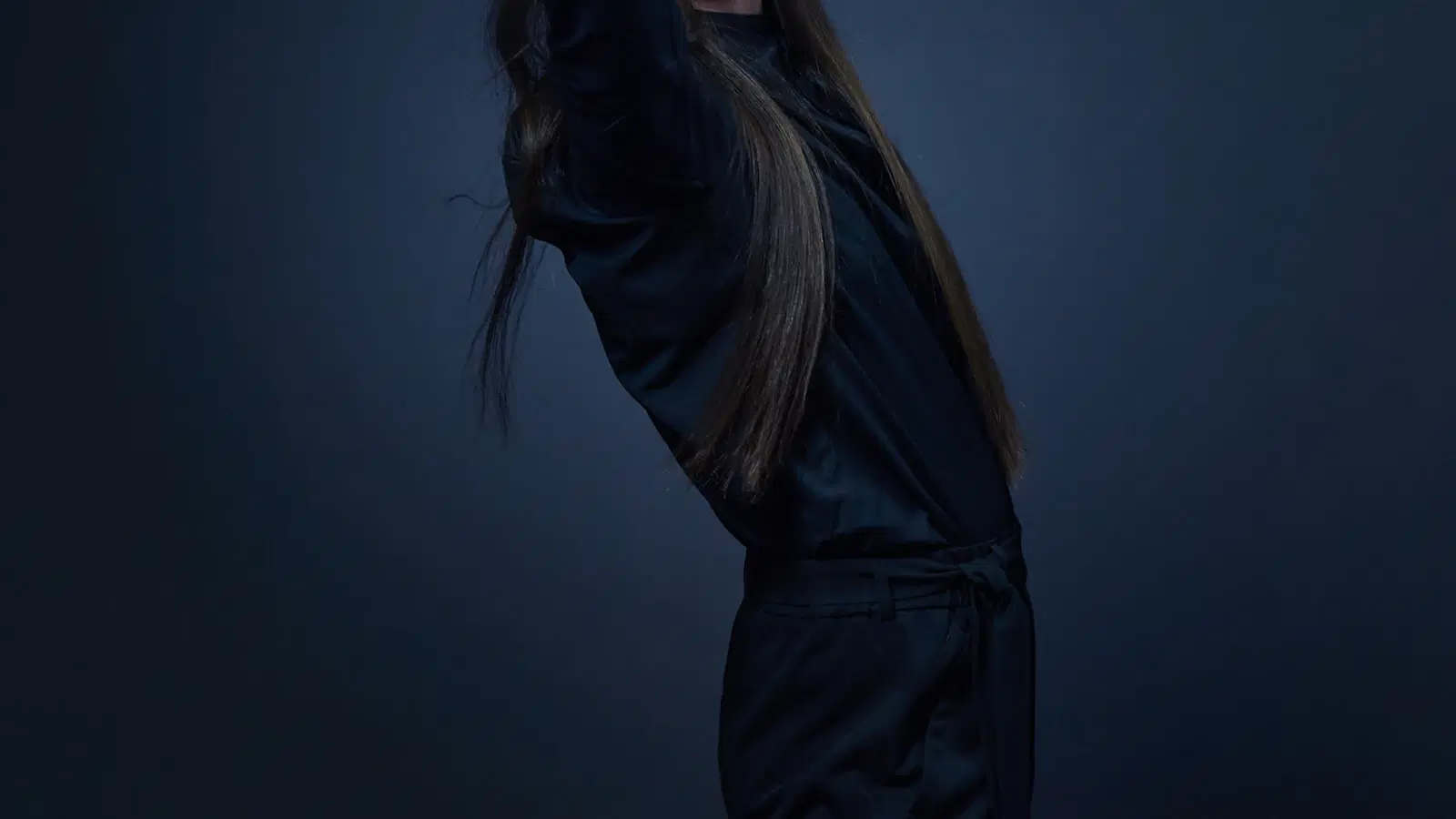 Emo femboy outfit — fitted black band tee, pleated mini-skirt, black striped thigh-highs, converse high-tops, and a studded belt