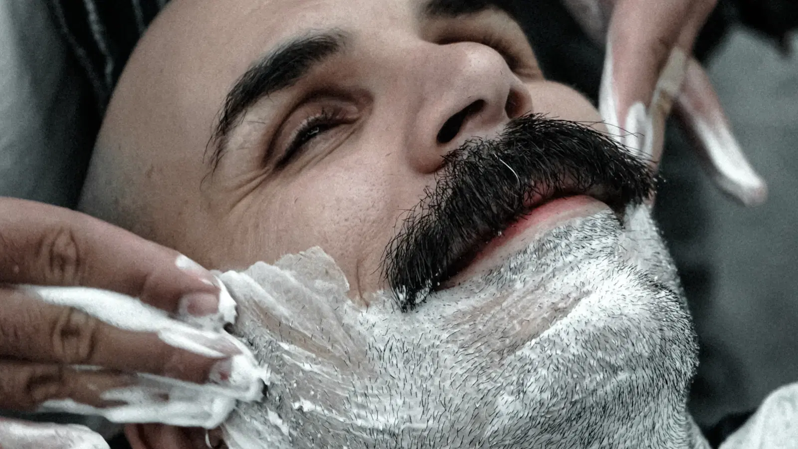 The femboy shaving routine — full-body bump-free sub-30-minute setup with bikini razor, slip cream, timer, and post-shave balm on a pink-lit bathroom counter