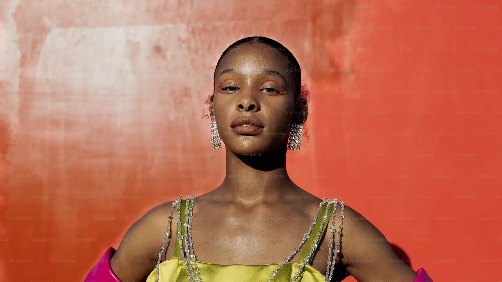 Feminine gesture — softened wrist position, fingers relaxed together, elbow resting close to the ribs while the forearm moves