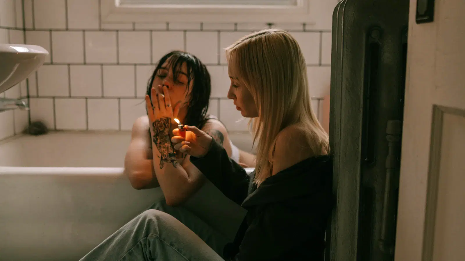 Man showering to soften pubic hair before shaving — steam, hot water, relaxed posture for an 8-10 minute pre-shave warm-up