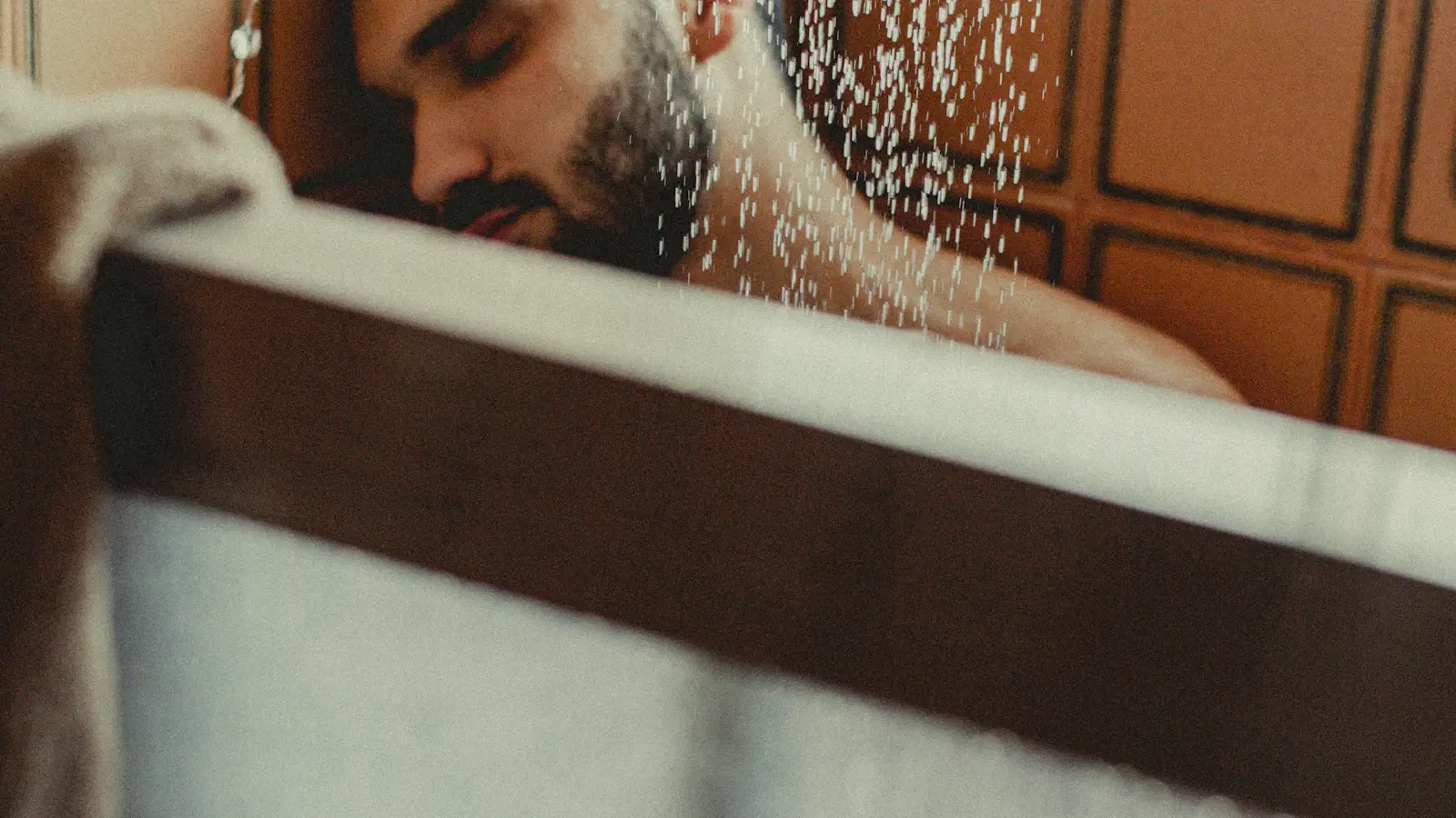 Second-pass butt shaving technique — shaving across the hair grain with re-applied cream for maximum smoothness without going against the grain