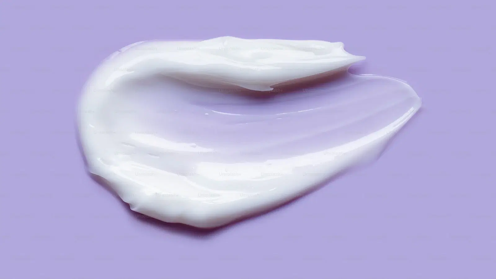 Fogless suction-mounted shower mirror positioned at knee height for butthole shaving — clear view of the area with both hands free