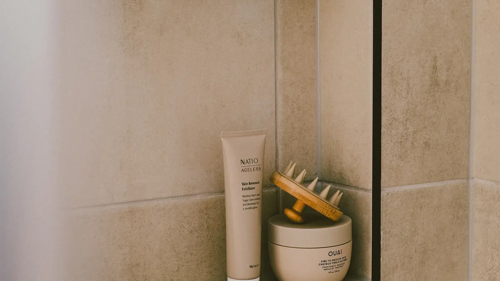 Amber-gold ball of sugaring paste held between fingers — the sugar manzilian hair removal method for men, explained